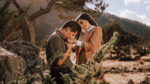 Husband gently kisses his wife’s hands as they share a warm smile